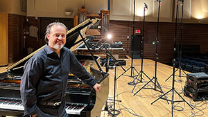 Paul Cardall is seen at the New York Steinway grand piano with a matched pair of Sanken CO-100K microphones in the recording studio at Baldwin Wallace University
